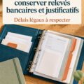 Femme examinant des relevés bancaires sur une table, entourée de documents importants.